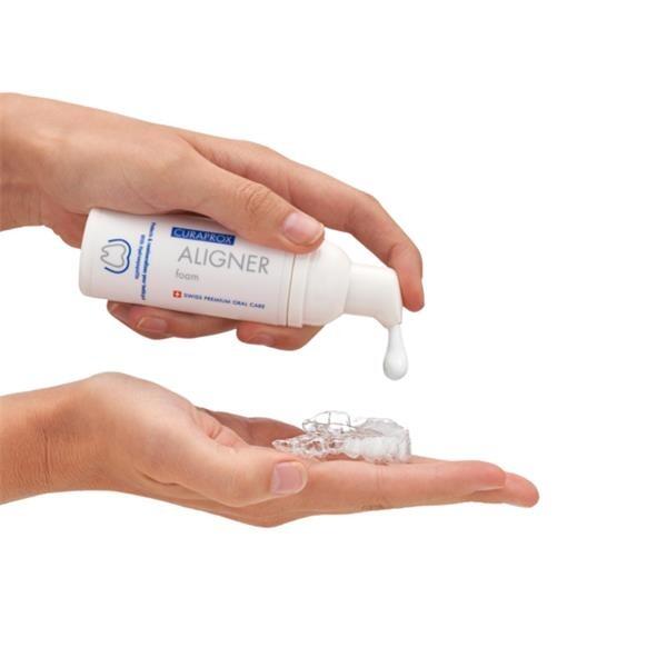 braces cleaner in hand
