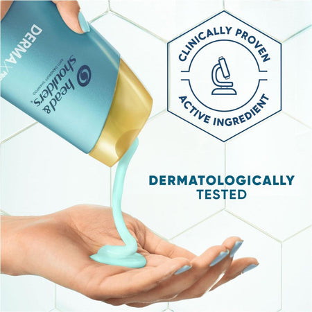 Head & Shoulders DermalMAX hand and shoulder gel being dispensed from its blue and gold tube into an open hand, set against a white hexagonal tiled background with 'DERMATOLOGICALLY TESTED' and 'CLINICALLY PROVEN ACTIVE INGREDIENT' text overlays.