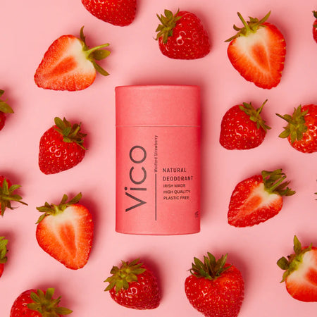 Pink VICO deodorant stick surrounded by strawberries on a pink background